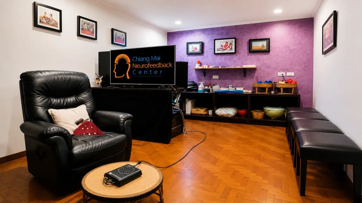 A neurofeedback training room at Chiang Mai Neurofeedback Center with a BrainMaster system, EEG cap, and brain-training equipment